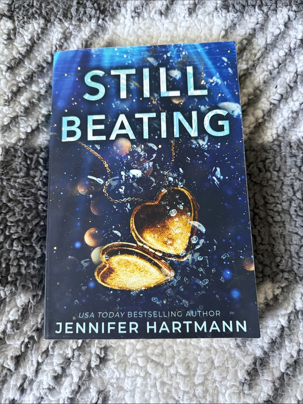 Still Beating by Jennifer Hartmann - Blue Cover with Gold Heart Locket